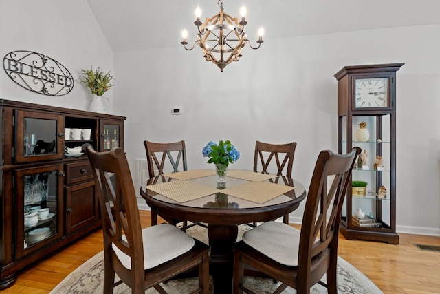 200 Blackberry Trl, Sapphire, NC 28774 - dining area featuring a chandelier, light wood-style flooring, and lofted ceiling