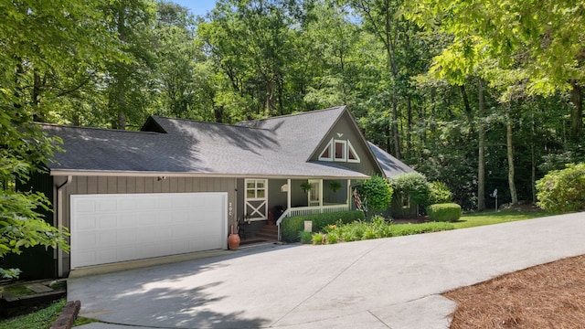 200 Blackberry Trl, Sapphire, NC 28774 - view of front of home with a porch, driveway, an attached garage, and a shingled roof