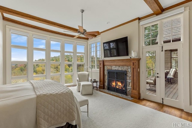 bedroom with multiple windows, beam ceiling, access to outside, and ceiling fan