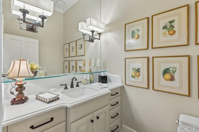 bathroom with vanity, crown molding, toilet, and an inviting chandelier