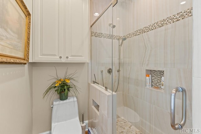 bathroom with a shower with door and toilet