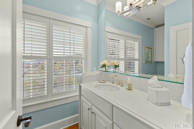 bathroom with ornamental molding and vanity