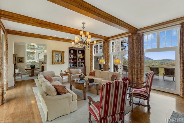 living room featuring a mountain view, a wealth of natural light, and beam ceiling