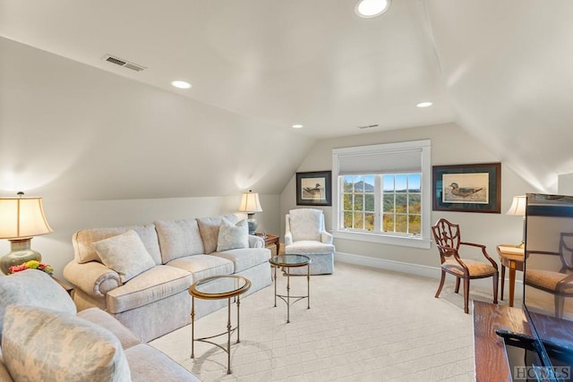 carpeted living room with vaulted ceiling