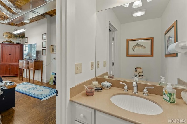 bathroom featuring hardwood / wood-style flooring and vanity