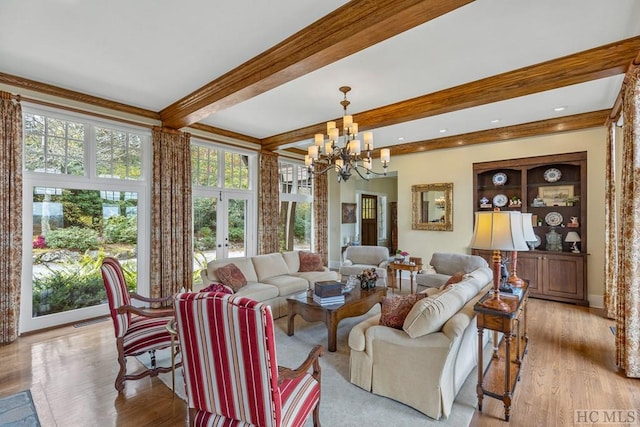 living room featuring beam ceiling, an inviting chandelier, light hardwood / wood-style floors, and french doors