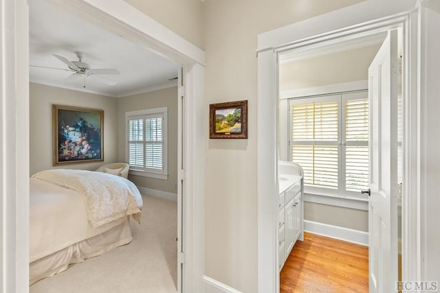 bedroom with crown molding, light wood-type flooring, and ceiling fan