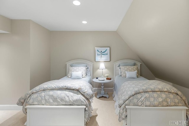 bedroom featuring vaulted ceiling and light carpet