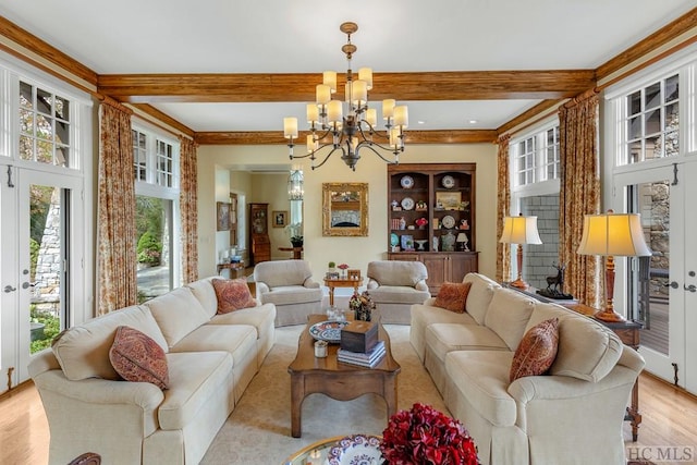 living room featuring a notable chandelier, beam ceiling, and light hardwood / wood-style floors