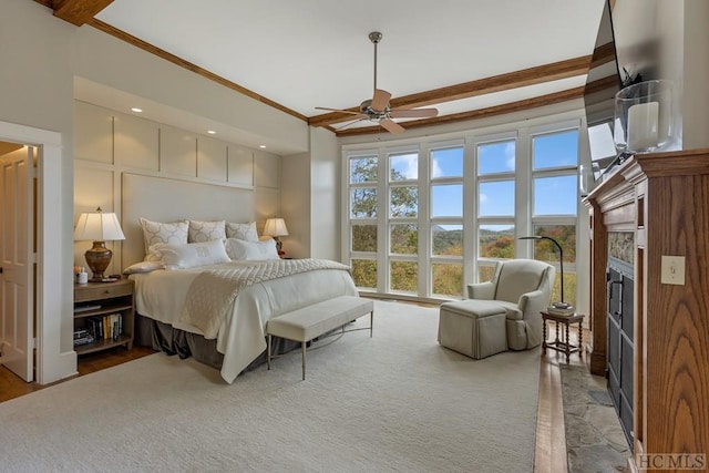 bedroom featuring crown molding, beamed ceiling, and ceiling fan