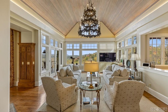 sunroom featuring a notable chandelier, wood ceiling, and vaulted ceiling