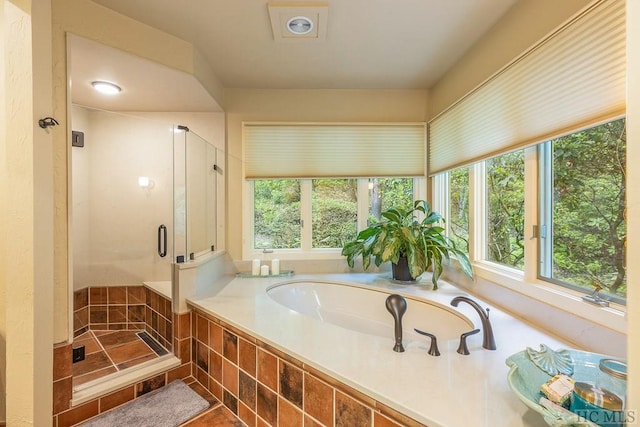 bathroom with independent shower and bath and tile patterned floors