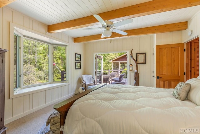 bedroom with beam ceiling, access to outside, ceiling fan, and carpet