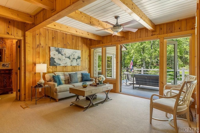 sunroom / solarium featuring beam ceiling and ceiling fan