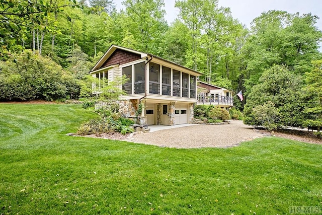 1213 Bull Pen Rd, Cashiers, NC 28717 - back of property featuring driveway, a lawn, a sunroom, an attached garage, and stone siding