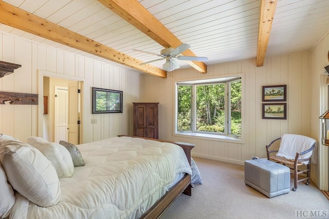 carpeted bedroom with beam ceiling and ceiling fan