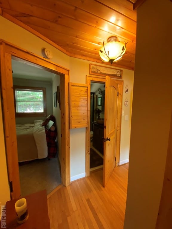 hallway with wood ceiling and light wood-type flooring