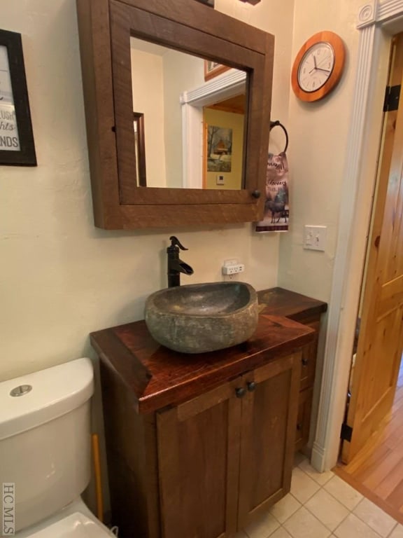 bathroom with vanity, tile patterned floors, and toilet