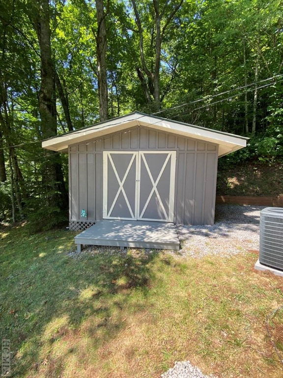 view of outbuilding with a yard and cooling unit