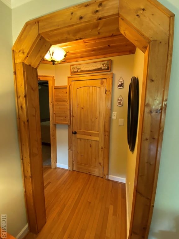 corridor with light hardwood / wood-style floors