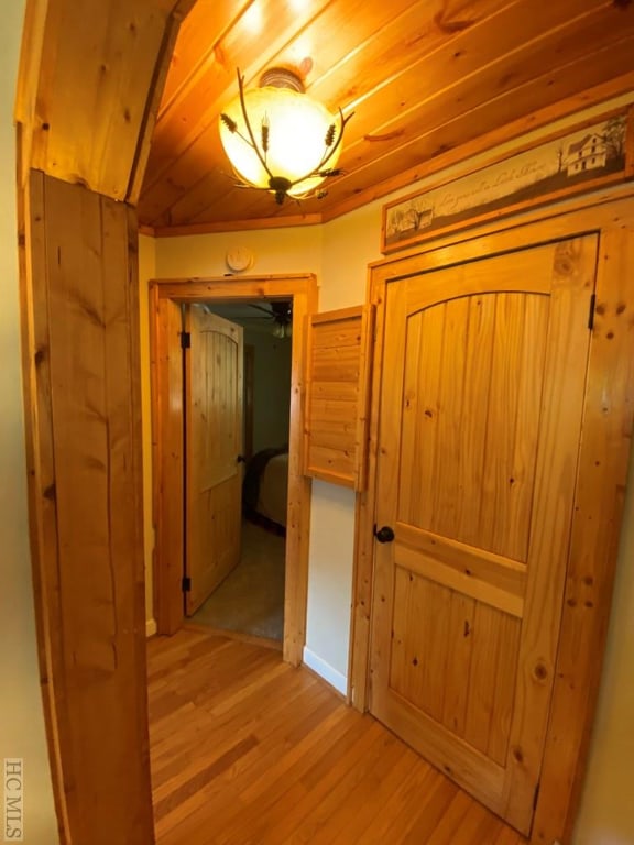 hall with wooden ceiling and light hardwood / wood-style flooring