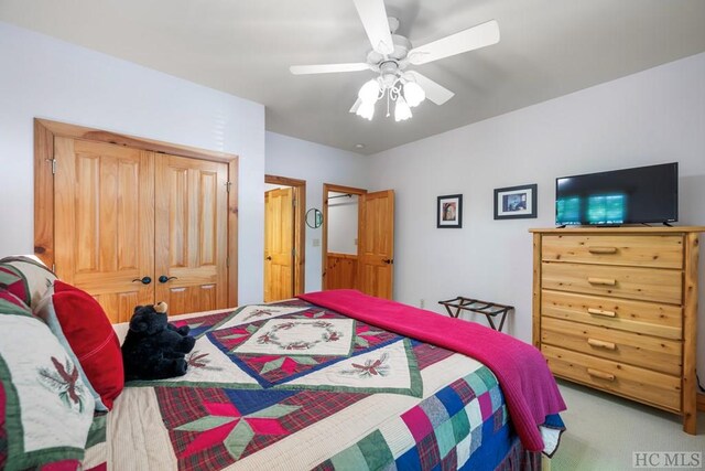 bedroom featuring a closet, ceiling fan, and carpet flooring