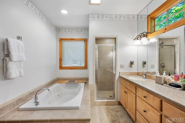 bathroom with vanity and separate shower and tub