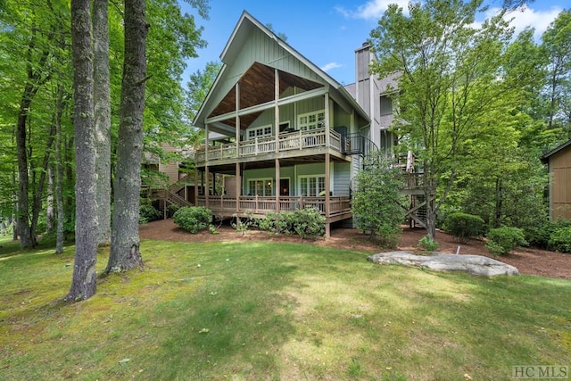 back of house featuring a yard and a deck