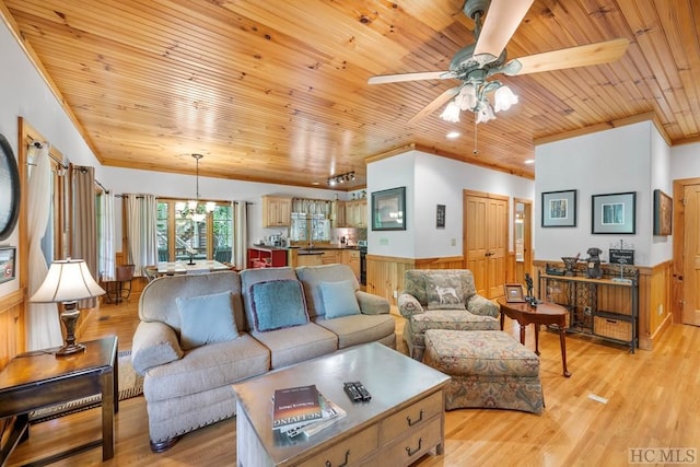 living room featuring ceiling fan with notable chandelier, wooden walls, light wood-type flooring, and wooden ceiling