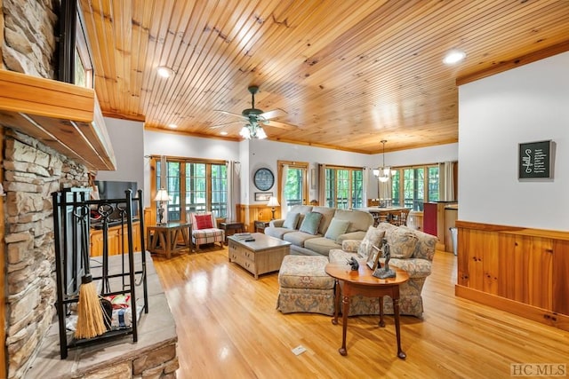 living room with a stone fireplace, plenty of natural light, wooden ceiling, and light wood-type flooring