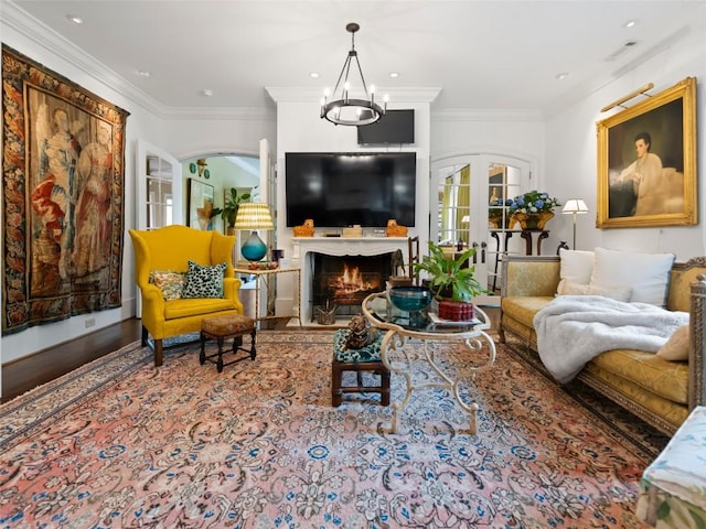13084 Canada Rd, Tuckasegee, NC 28783 - living area with a chandelier, french doors, crown molding, a warm lit fireplace, and arched walkways