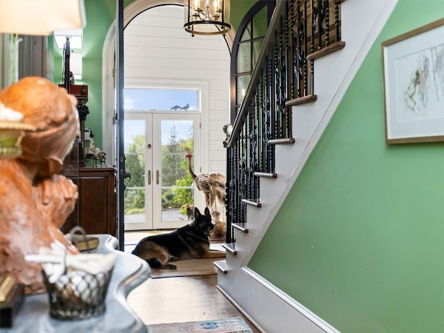 13084 Canada Rd, Tuckasegee, NC 28783 - stairs with french doors, a chandelier, and wood finished floors