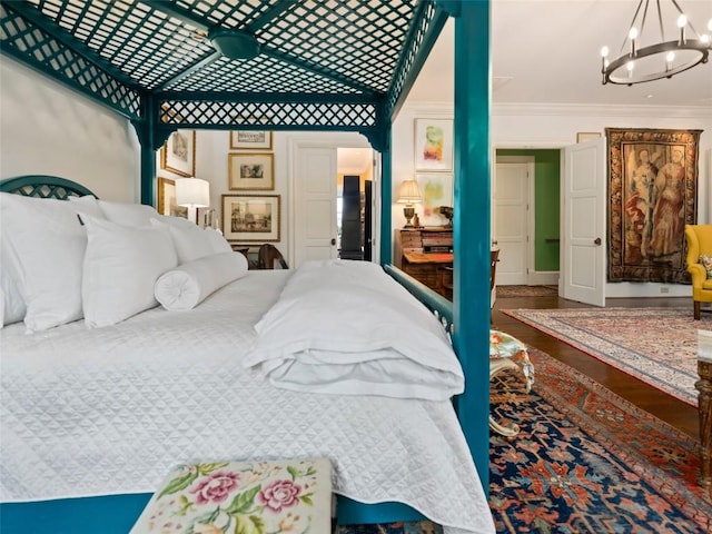 13084 Canada Rd, Tuckasegee, NC 28783 - bedroom featuring a chandelier, ornamental molding, and wood finished floors