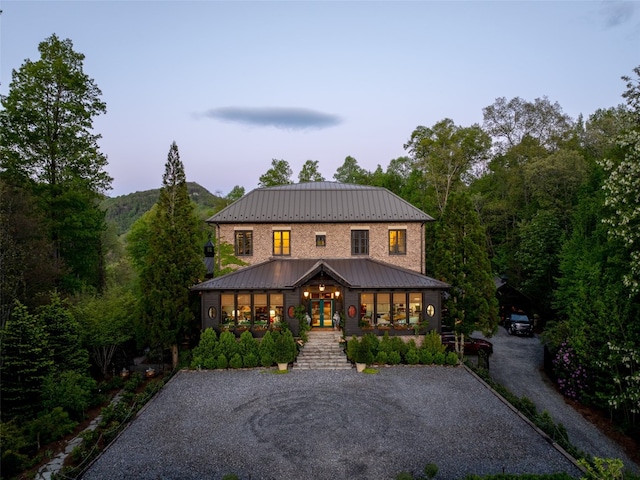 13084 Canada Rd, Tuckasegee, NC 28783 - view of front of house featuring a standing seam roof, metal roof, french doors, and driveway
