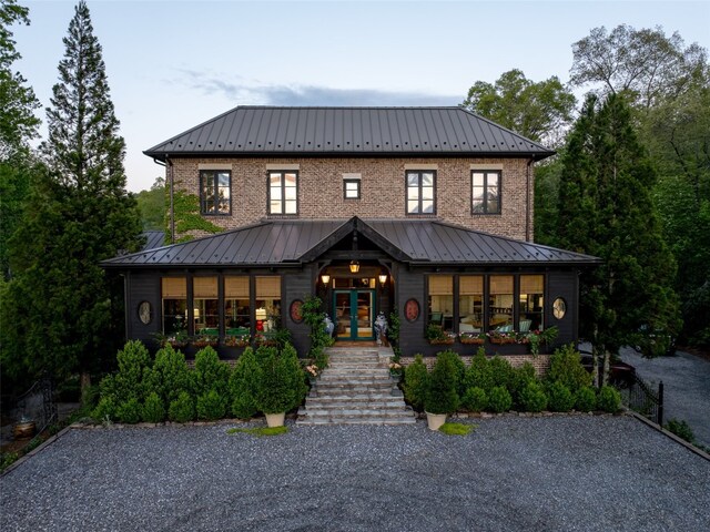 13084 Canada Rd, Tuckasegee, NC 28783 - view of front facade with stairway, metal roof, brick siding, and french doors