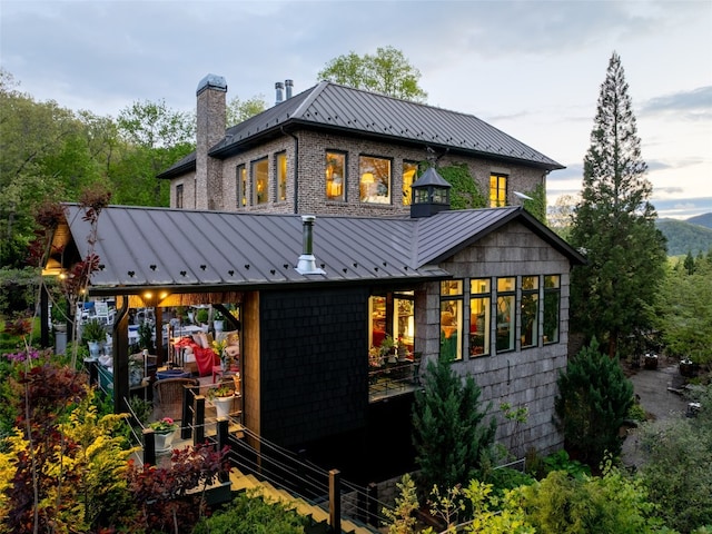 13084 Canada Rd, Tuckasegee, NC 28783 - rear view of house featuring a standing seam roof, a chimney, and metal roof