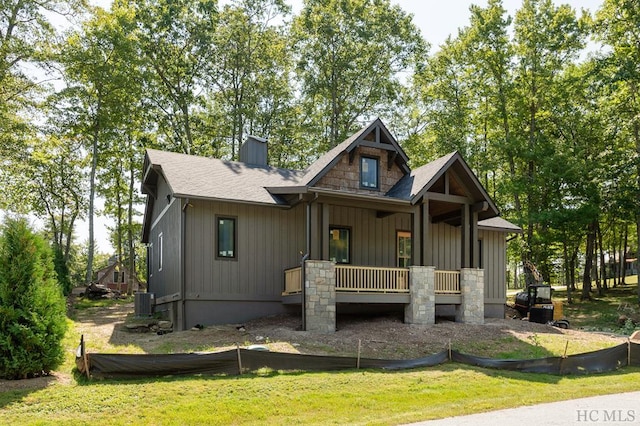 view of front facade with central AC unit, a front yard, and covered porch