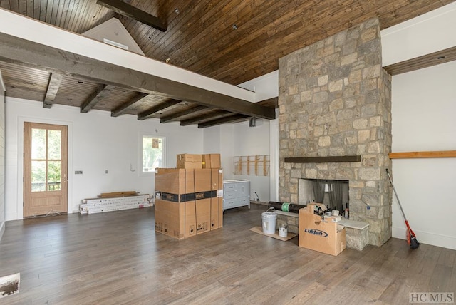 unfurnished living room with wood ceiling, beam ceiling, dark wood-type flooring, and a wealth of natural light