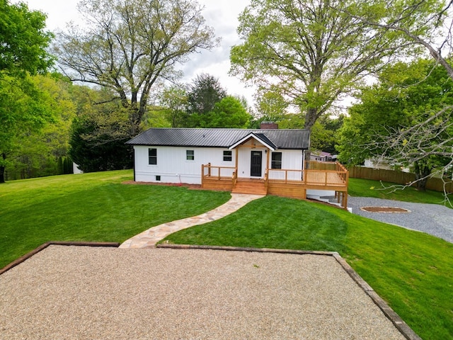 94 Breezy Knob Rd, Franklin, NC 28734 - view of front of home with a front yard, a chimney, metal roof, a wooden deck, and board and batten siding