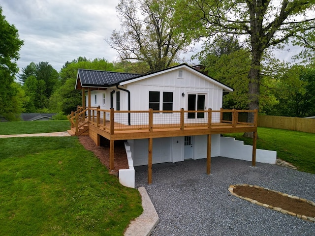94 Breezy Knob Rd, Franklin, NC 28734 - back of property featuring board and batten siding, a wooden deck, gravel driveway, a carport, and metal roof