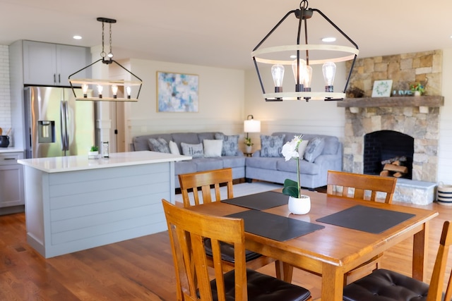 94 Breezy Knob Rd, Franklin, NC 28734 - dining area featuring dark wood finished floors, a stone fireplace, a chandelier, and recessed lighting
