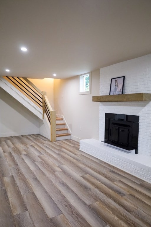 94 Breezy Knob Rd, Franklin, NC 28734 - unfurnished living room featuring wood finished floors, stairs, baseboards, a fireplace, and recessed lighting