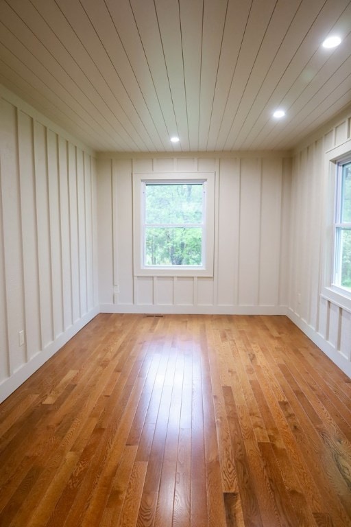 94 Breezy Knob Rd, Franklin, NC 28734 - unfurnished room featuring light wood-style flooring, a decorative wall, wood ceiling, and recessed lighting