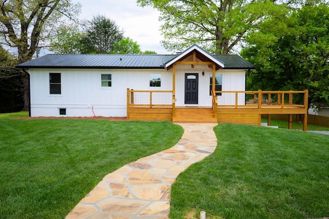94 Breezy Knob Rd, Franklin, NC 28734 - modern farmhouse style home featuring a wooden deck, a front yard, board and batten siding, and metal roof