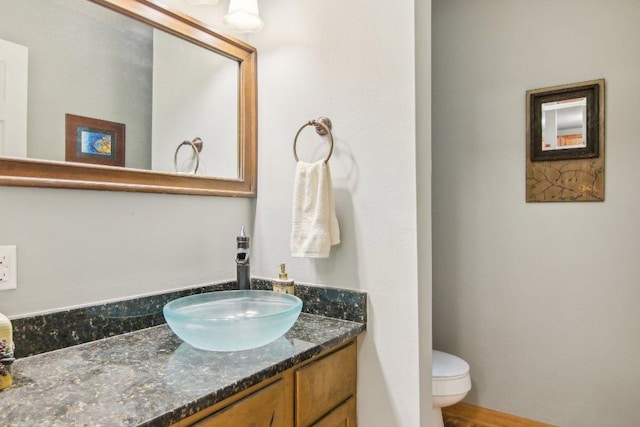 half bathroom with toilet and vanity