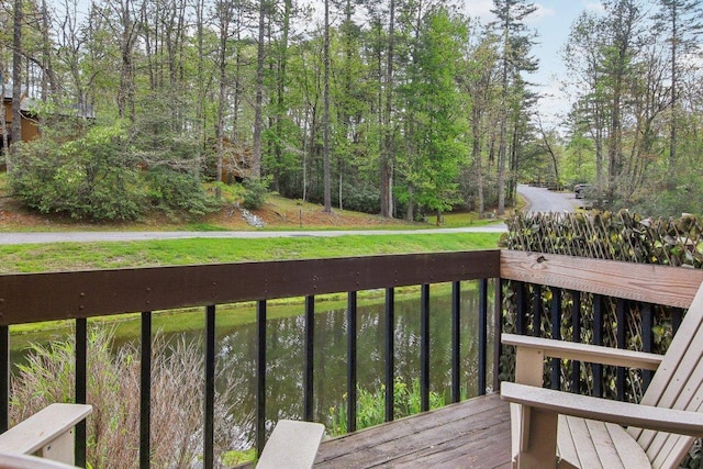 wooden deck featuring a lawn