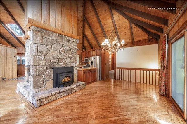 334 Back Nine Ln, Sapphire, NC 28774 - unfurnished living room with a wooden ceiling with exposed beams, light wood-style floors, a chandelier, high vaulted ceiling, and wood walls