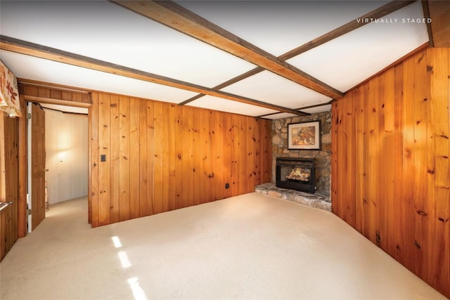 334 Back Nine Ln, Sapphire, NC 28774 - unfurnished living room with wood walls, carpet flooring, a stone fireplace, and beam ceiling
