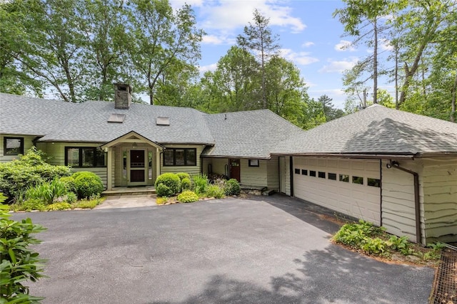 334 Back Nine Ln, Sapphire, NC 28774 - view of front facade featuring a garage, a chimney, driveway, and roof with shingles