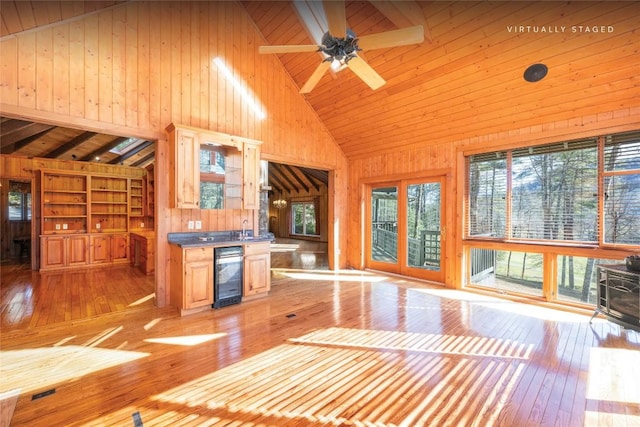 334 Back Nine Ln, Sapphire, NC 28774 - kitchen with beverage cooler, wooden walls, light wood-style flooring, high vaulted ceiling, and wood ceiling